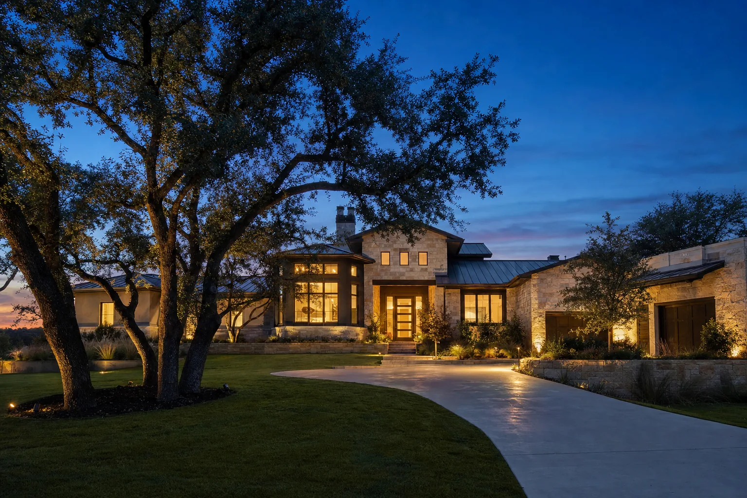 Custom Texas home at twilight with warm interior lights