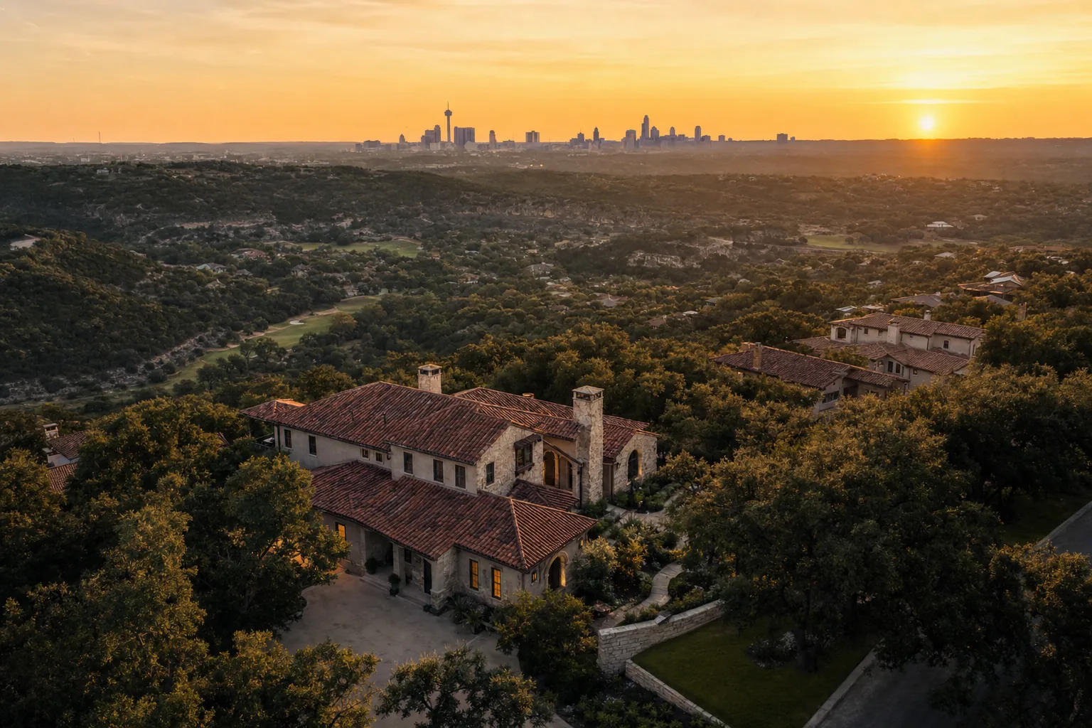 Hill Country custom home at golden hour with San Antonio skyline in the distance